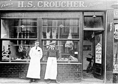 Henry-Croucher-stands-outside-his-butcher’s-shop-at-70-Mount-Pleasant-Road.-1912.